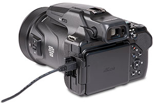 Nikon Coolpix P1000 with USB cable in camera port with door open